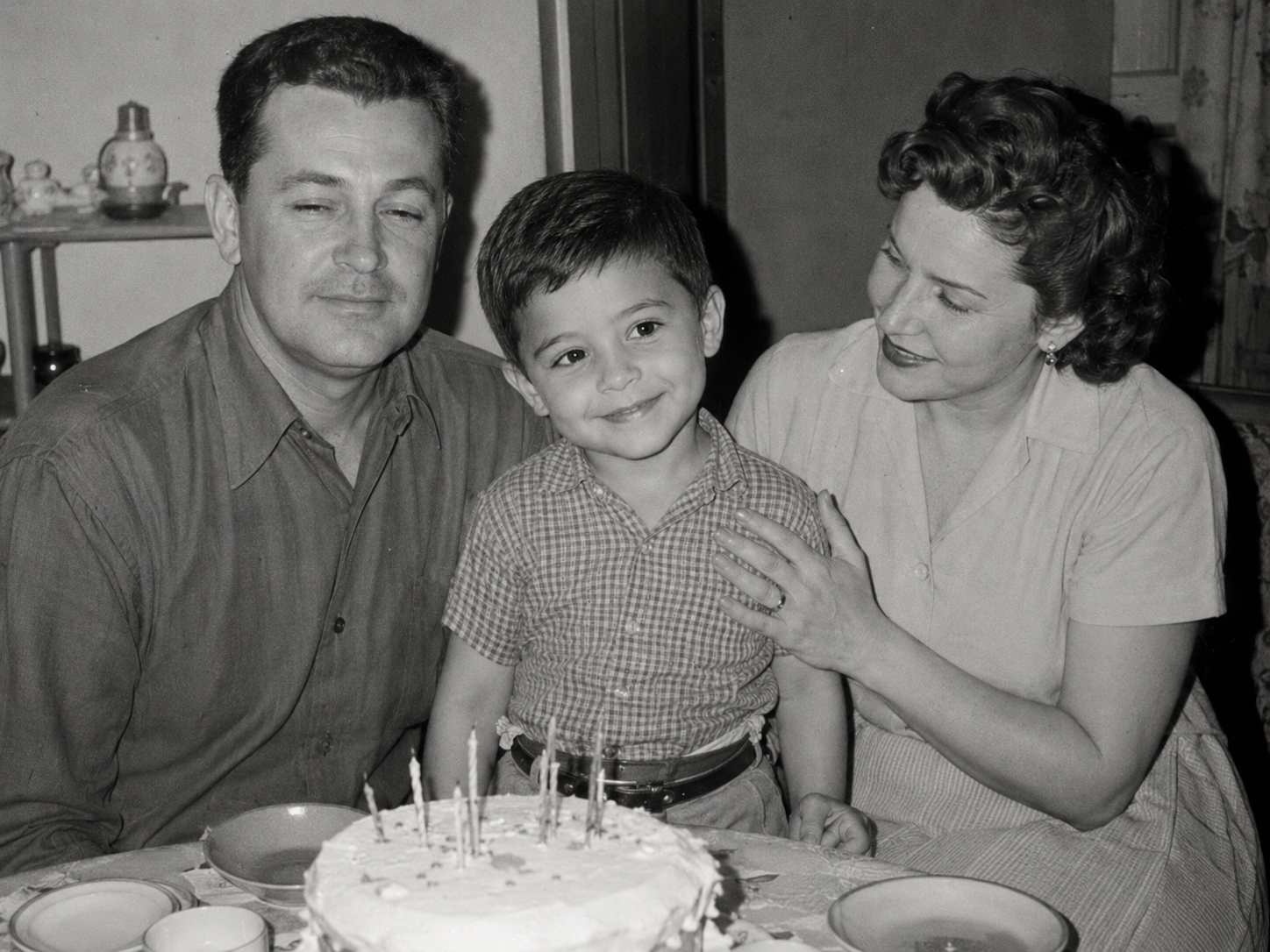 James as a child with his parents at a birthday table
